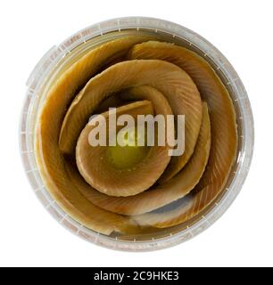 Preserved sardines marinated in oil in plastic container. Isolated over white background Stock Photo