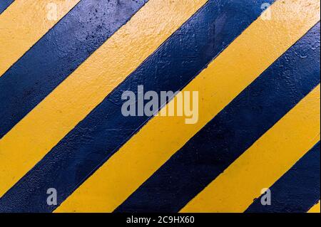 Black and yellow lines on wall. Danger sign Stock Photo