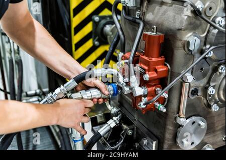 Industrial worker assembles agricultural equipment at plant Stock Photo