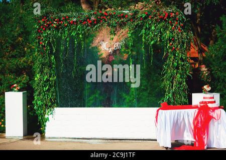 Beautiful unusual wedding decor. wall of flowers, lanterns in the photo area. Stock Photo