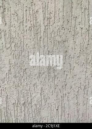 The texture of the plaster is bark beetle on the wall. Seamless grey texture. Stock Photo