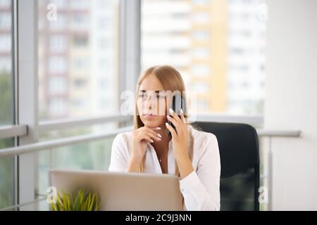 Focused woman working at her computer. Background for office startup Stock Photo