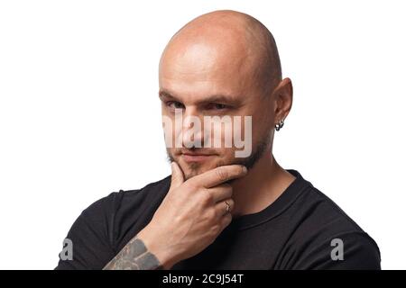 Image of bald scheming man in black shirt on white background Stock Photo