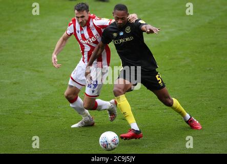 Brentford's Ethan Pinnock battles to hold off challenge from Stoke City's Lee Gregory during the Sky Bet Championship match at the Bet365 Stadium, Stoke. Stock Photo