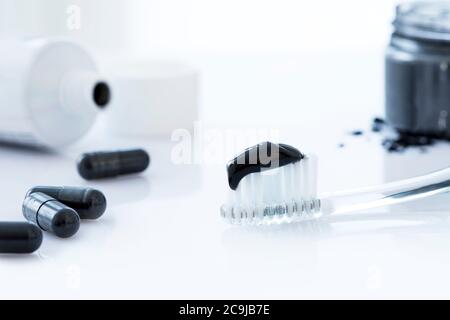 Charcoal toothpaste on a toothbrush. Stock Photo