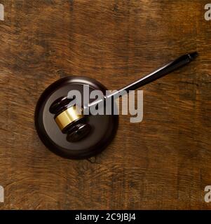Lawers gavel against wooden background. Stock Photo