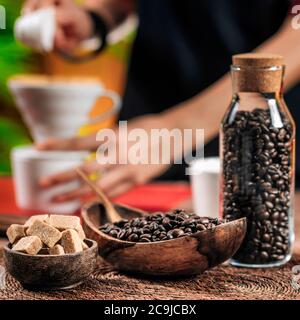 Coffee beans In wooden bowl. Making filter coffee with manual coffee dripper in the background. Stock Photo