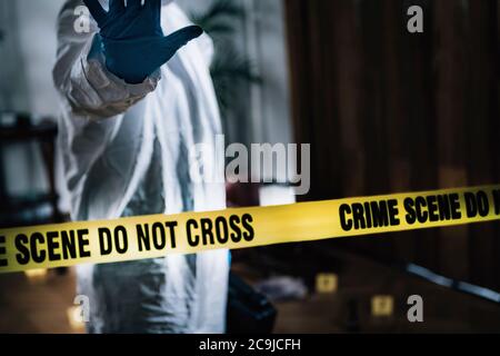 Crime scene. Forensics expert at a crime scene. Stock Photo