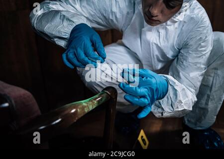 Crime scene. Forensics expert dusting for fingerprints at a crime scene. Stock Photo