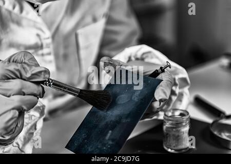 Forensic science investigator collecting fingerprints. Stock Photo