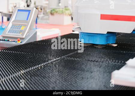Automated metal punching and cutting machine with control panel. Stock Photo