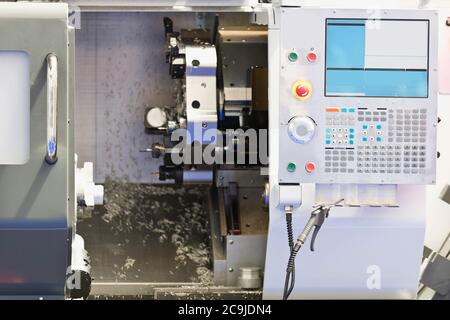 Automated CNC toolroom lathe with control console. Stock Photo