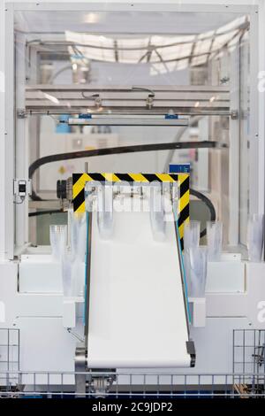 Manufacturing line for production of plastic cups, packaging for food industry. Stock Photo
