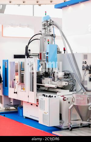 Injection moulding machine in a high tech industrial facility. Stock Photo