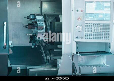 Automated CNC toolroom lathe with control console. Stock Photo