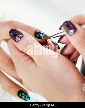 Painting fingernails in nail salon. Stock Photo