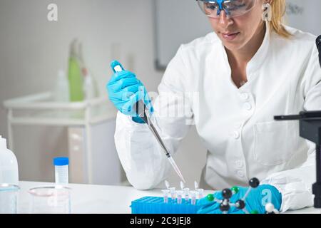 Scientist pipetting sample. Stock Photo
