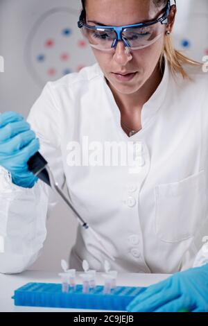 Scientist pipetting sample. Stock Photo