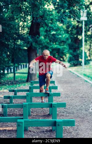 Fit senior man exercising in a park. Stock Photo