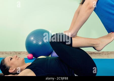 Physical therapist working with patient. Stock Photo