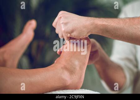 Woman having relaxing foot massage. Stock Photo