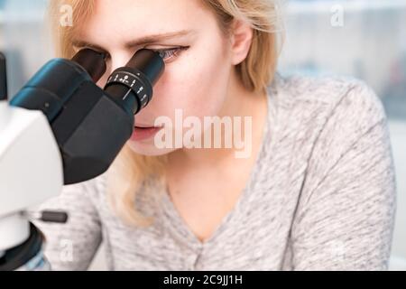Student using microscope. Stock Photo