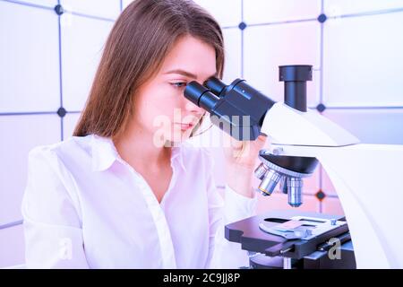Researcher using microscope. Stock Photo