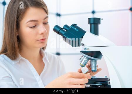 Researcher using microscope. Stock Photo