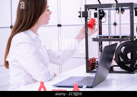 Designer working with 3D printer. Stock Photo