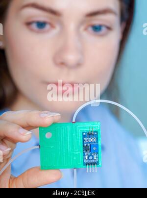 Researcher with lab on a chip. Stock Photo