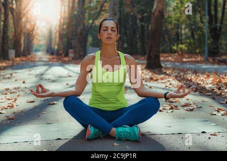 Woman doing yoga in the park. Stock Photo