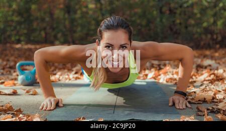 Doing push-ups. Hiit or high intensity interval training outdoors. Stock Photo