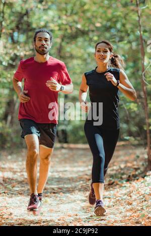 Friends enjoy running outdoors. Stock Photo