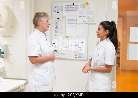 Nurses talking and laughing. Stock Photo