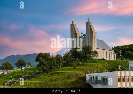 Akureyrarkirkja Lutheran Church This is an important and popular landmark of Akureyri city in Northern Iceland, in the evening sky blue vanilla. In th Stock Photo