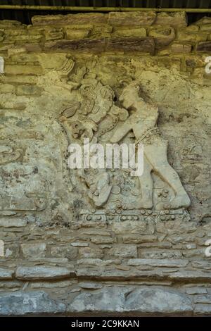 A stucco bas relief showing a captor and captive on the front of the Temple of the Murals at the ruins of the Mayan city of Bonampak in Chiapas, Mexic Stock Photo