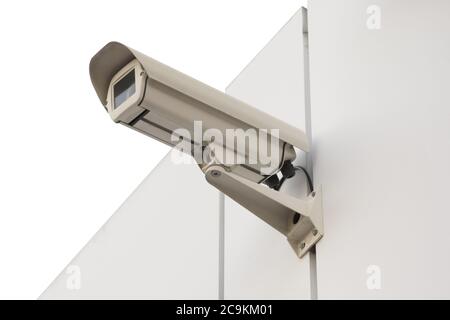 Security camera isolated on white wall. Isolated object. Stock Photo