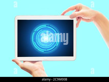 Hands holding working tablet isolated on pastel background. Cyber technology remote work concept Stock Photo