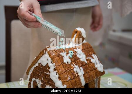 making a gingerbread house on kitchen table Stock Photo