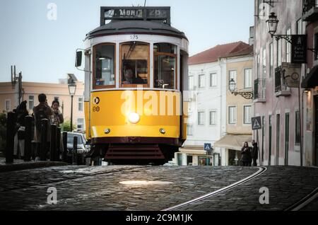 LISBON, PORTUGAL - FEBRUARY 2, 2019: Classic traditional yellow trolley tramcar in Lisbon, Portugal, near the church of Santa Lucia on february 2, 201 Stock Photo