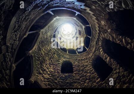 SINTRA, PORTUGAL - FEBRUARY 5 2019: The famous initiation well of the Quinta da Regaleira, masonic spiral staircase of the romantic age in Sintra, Por Stock Photo