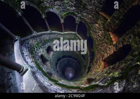 SINTRA, PORTUGAL - FEBRUARY 5 2019: The famous initiation well of the Quinta da Regaleira, masonic spiral staircase of the romantic age in Sintra, Por Stock Photo