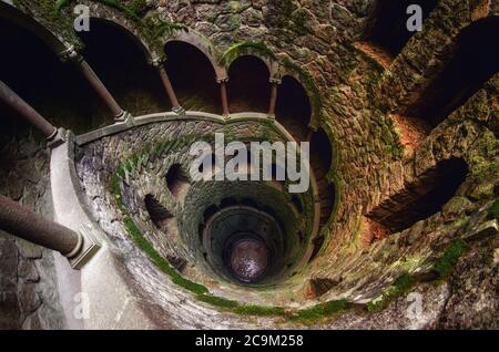 SINTRA, PORTUGAL - FEBRUARY 5 2019: The famous initiation well of the Quinta da Regaleira, masonic spiral staircase of the romantic age in Sintra, Por Stock Photo