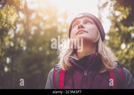 Young woman hiking and going camping in nature Stock Photo