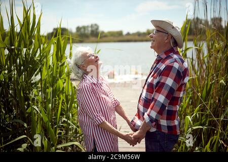 Happy old couple on picnic enjoying the sun Stock Photo