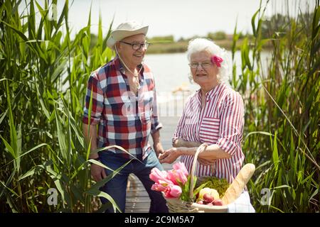 Happy old couple ready for picnic on a sunny weather Stock Photo