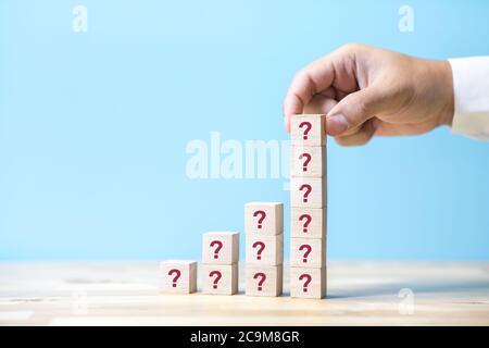 Question and answer concepts  with business person and sign on wood box.performance of human.learning and study.iq to success Stock Photo