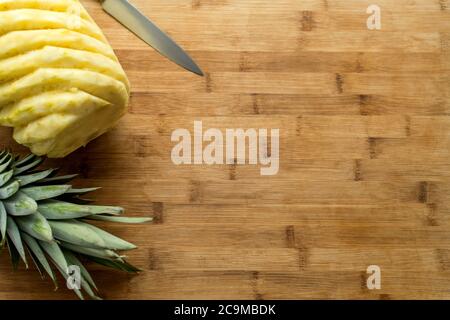 Ripe perfectly peeled pineapple, on a wooden background. Stock Photo