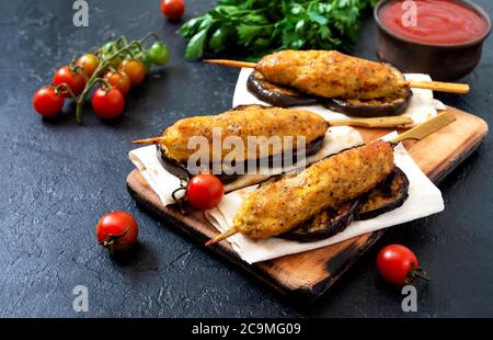 Lula kebab with grilled eggplant on pita bread. chicken kebabs on a skewer with vegetables. Stock Photo