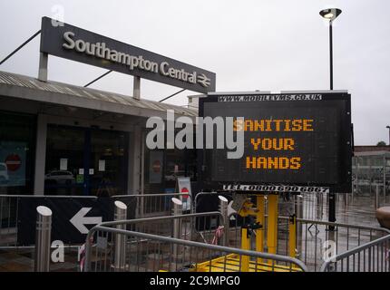 Digital information sign at Southampton railway station showing Covid-19 safety messages to commuters as they enter the station. Stock Photo